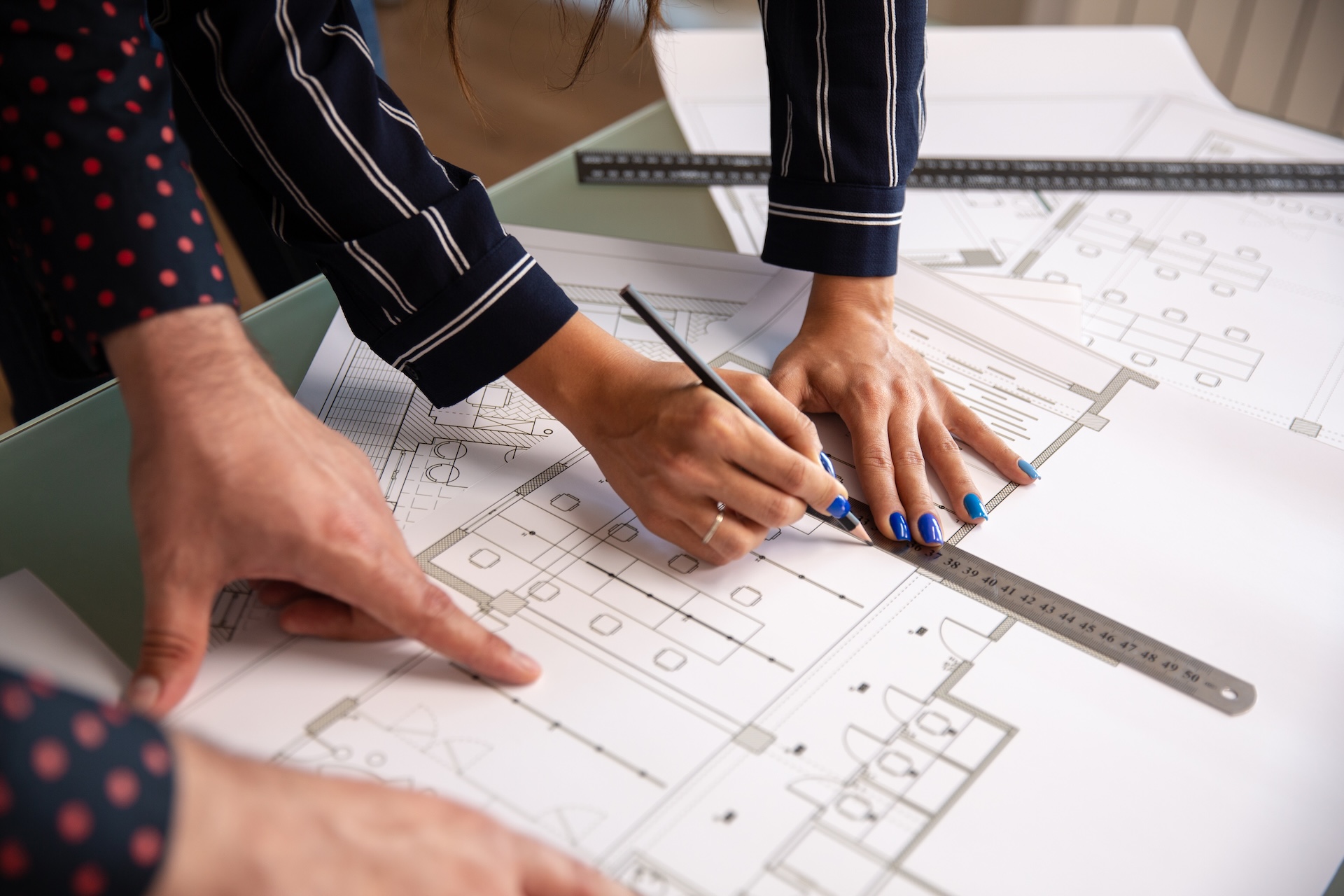 close up with hands two architects who draw something house plan blueprints new construction plan | TZB PRO s.r.o.